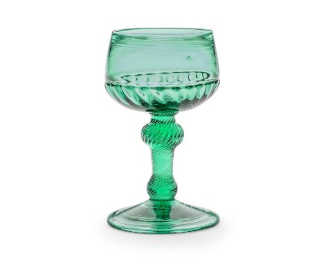 A rare green tinted incised twist baluster champagne or wine glass, circa 1750-60In light green glass, the distinctive cup-sh