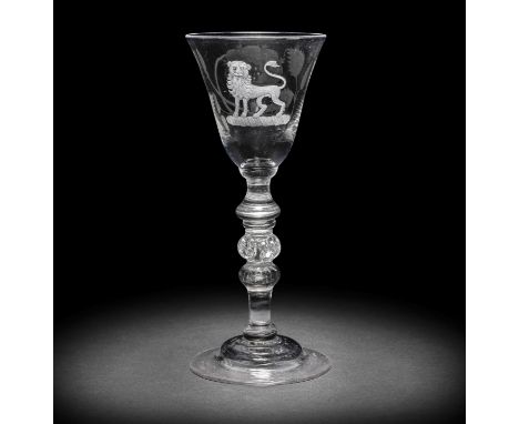 A fine engraved Jacobite light baluster wine glass, circa 1750The slightly flared round funnel bowl with a seven-petalled ros