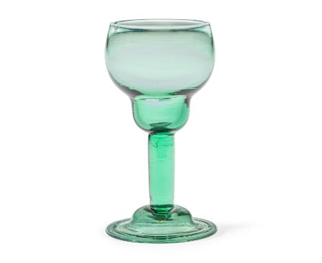 A green tinted plain stem goblet, circa 1750In light green glass, the generous cup-shaped double ogee bowl raised on a plain 