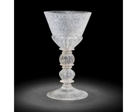 A rare and unusual engraved coin goblet containing an English coin, circa 1680-90The generous round funnel bowl moulded with 