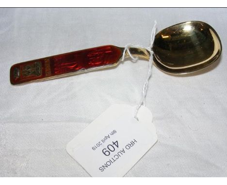 A boxed silver gilt 'Bergen', Norway spoon with local scenes beneath red enamel 
