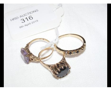 Two gold rings and one other ring 
