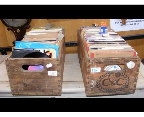 Two vintage bottle crates containing various 45 rpm records, mostly 1970's 