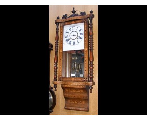 A late 19th century walnut wall clock with marquetry decoration, a visible pendulum below two train movement - height 95cm 