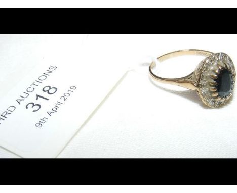 A 9ct gold diamond and sapphire ring - Size Q