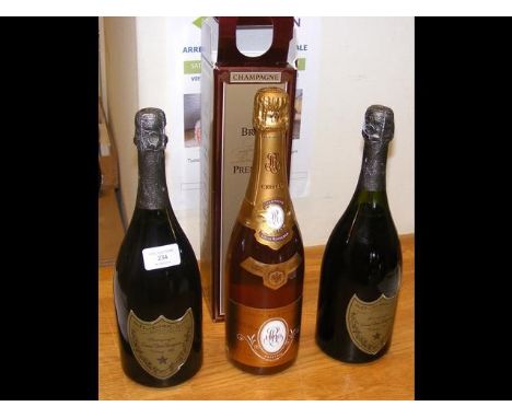 A bottle of 1980 Vintage Dom Perignon, together with a 1976 Dom Perignon and a Louis Roederer bottle of Champagne 1990 CONDIT