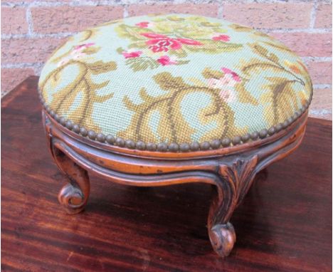 A CONTEMPORARY CIRCULAR FOOTSTOOL raised on four cabriole supports and with floral tapestry cover, 35cm diameter