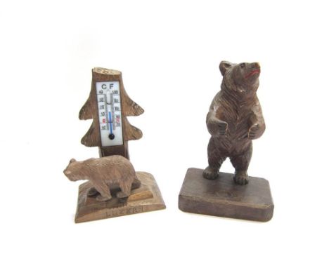 TWO BLACK FOREST CARVED WOODEN BEARS one standing on its hind legs with arms outstretched, to form a pipe stand, 12.5cm high;