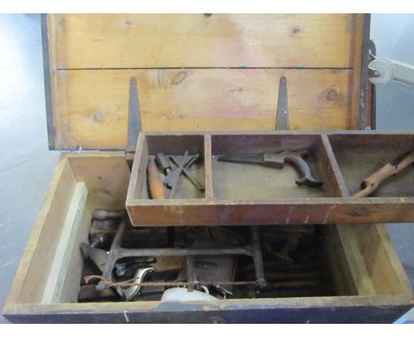A STAINED WOODEN TOOLBOX with a lift out three-compartment tray; together with a quantity of wood-working tools, including pl
