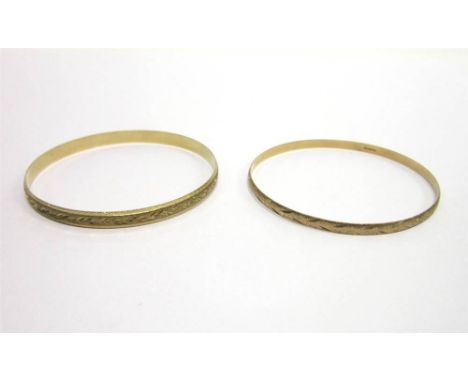 A 9CT GOLD BANGLE with diamond cut decoration; with another similar bangle; 15.5g gross