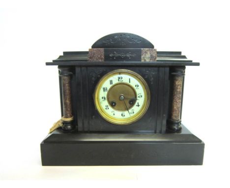 A VICTORIAN MANTLE CLOCK with brass and enamel dial, and contained in a black slate case with pillar supports, 28cm high