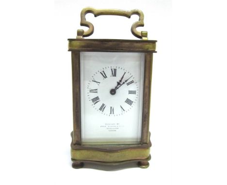 A FRENCH BRASS CASED CARRIAGE CLOCK of serpentine outline, the enamel dial with Roman numerals and inscribed 'examined by Joh