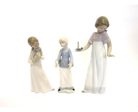 TWO NAO STANDING FIGURES OF GIRLS one with a chamber stick in her right hand, the other holding a puppy; and a Cascades figur