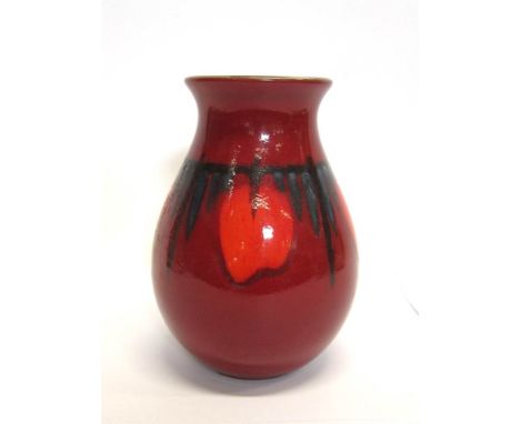 A POOLE POTTERY VASE decorated with orange and red glaze, of ovoid form and with flared rim, 21.5cm high