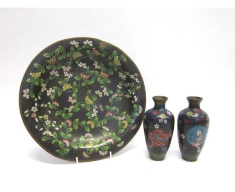 A PAIR OF CLOISONNE ENAMEL VASES decorated with floral sprays and butterflies and a similar shallow footed dish decorated wit