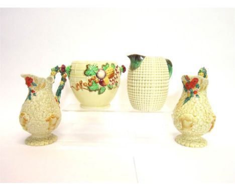 A PAIR OF CLARICE CLIFF 'CELTIC HARVEST' PATTERN JUGS 22cm high; together with an A.J. Wilkinson Ltd jug and biscuit barrel w