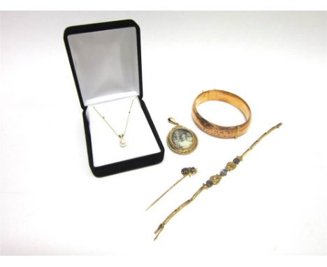 A HINGED BANGLE stamped '9ct Sil.Lined'; with a double sided picture pendant, stamped '9ct'; a bracelet, set with three colou