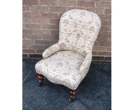 A LADIES VICTORIAN BUTTON BACK CHAIR on turned frontal supports and castors 
