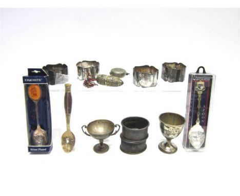 A PAIR OF SILVER NAPKIN RINGS with engine turned decoration; a silver egg cup; and a small two handled silver trophy cup; 75.