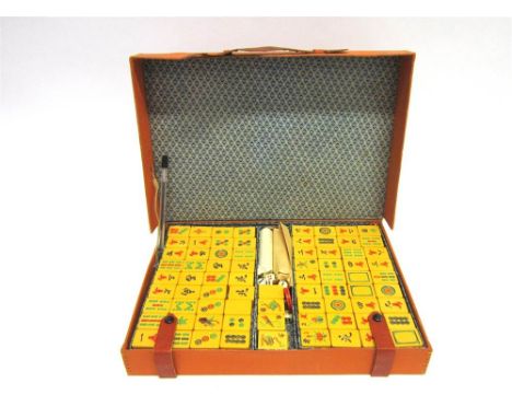 A MAHJONG SET mid 20th century, with moulded plastic playing pieces, cased.