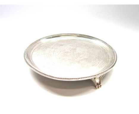 A GEORGE III SILVER SALVER BY Elizabeth Jones, London 1784, of circular outline, beaded rim, on three bracket supports, 17.8 