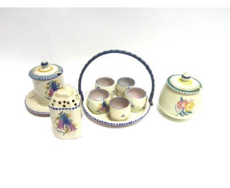 A POOLE POTTERY CARTER, STABLER AND ADAMS SUGAR SIFTER 10cm high; two preserve pots with lids; and a group of five egg cups o