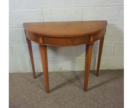 A pair of George III style demi lune console tables, 20th century, each with a central fan inlay and set on tapered square se