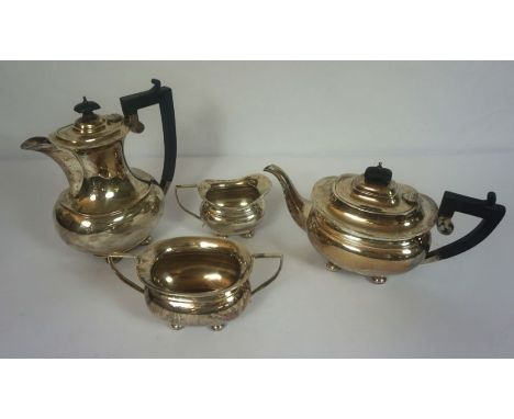 A four silver teaset, hallmarked Birmingham, 1923, comprising a teapot of waisted oval form, a matching hot water jug, milk j