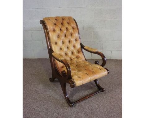 A Regency style mahogany  and leather Library bergere armchair, ,with a scrolled back, leather button upholstered seat and sc