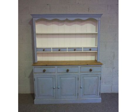 A modern stripped pine and light blue painted dresser, 20th century, with two shelves and small drawers over a base with thre