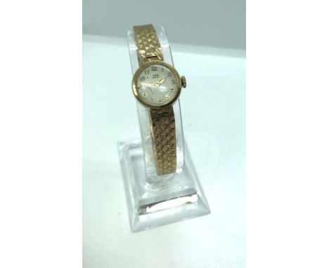 A gold cased Tudor Royal ladies dress watch, with a small 16mm diameter circular dial, Roman numerals, the fish-scale slender