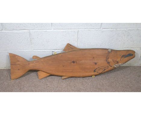 A vintage pine model of an Atlantic Salmon, 125cm long; together with an Egyptian camel saddle, 20th century, with leather cu