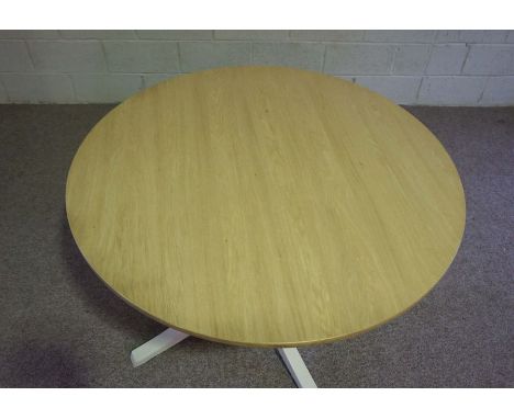 An Ercol ash topped circular dining table, model number: 1423BNP, the top on a painted box section base with four legs, the c