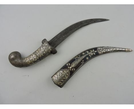 A Persian style dagger with a curved blade, the handle and scabbard decorated with foliage, L. 21cm.