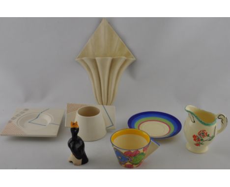 A Clarice Cliff Bizarre cup and saucer decorated with blue and green flowers together with a later Newport wall pocket and fo