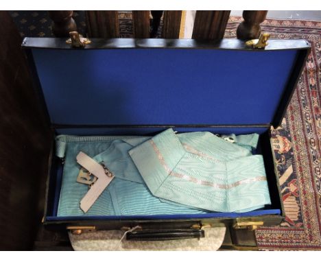 A rectangular black leather Masonic case containing a Masonic apron and sash
