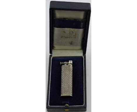 A silver Dunhill lighter, the body decorated with a basket-weave pattern, in presentation box with spare flints, H. 6.5cm. 