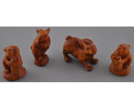 Four hardwood netsuke carvings modelled as hares