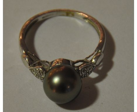 Black pearl ring with diamond set shoulder in a 9ct white gold ring.