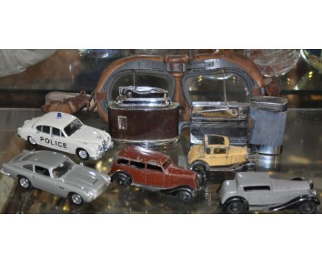 Two early Dinky die cast cars, two later cars, a pair of flying goggles and assorted vintage lighters
