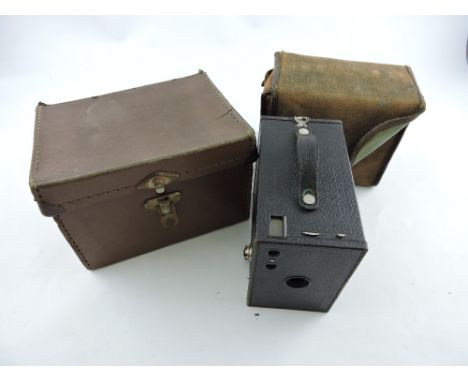 A Kodak No. 2 brownie camera in canvas case and outer box together with a Sankyo film cine camera in case plus two camera len