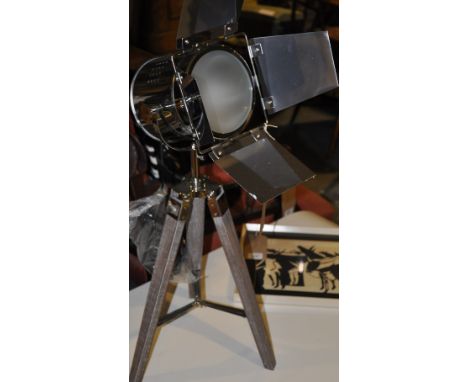 A chrome table lamp modelled as a vintage studio light on oak tripod. H: 70cm