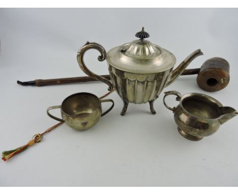 A silver-plated teapot, of fluted form and raised on pad feet, together with associated sucrier and milk jug, also including 