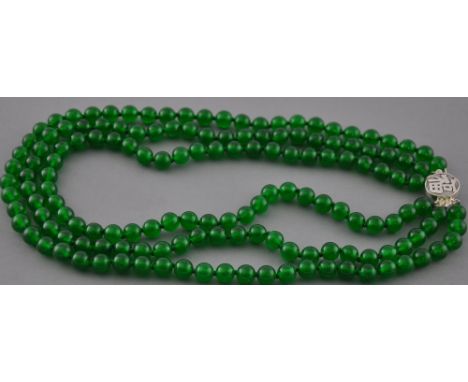 A triple row jade bead necklace with a silver clasp
