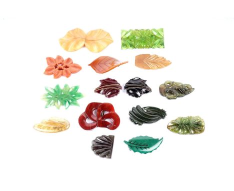 1930s Art Deco celluloid dress clips, brooches, and a buckle, each of a botanical design.