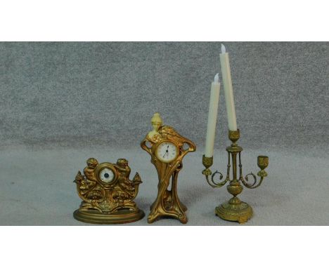 An art nouveau style resin clock with an elegant lady and floral motifs, an antique two branch gilded candle stick and gold p