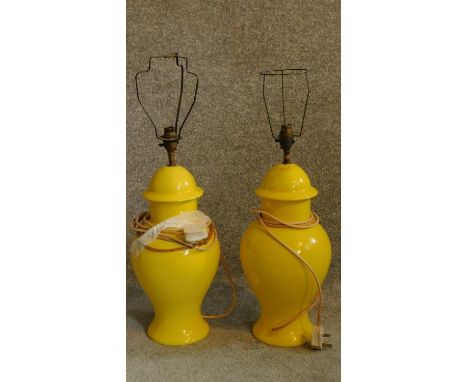 A pair of pale yellow ceramic table lamps. H.62cm 