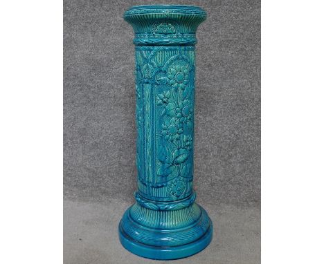 A Victorian blue glazed ceramic Burmantofts jardinere stand with sunflower decoration. H.69cm 