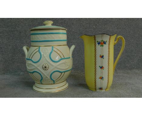 An antique hand painted jug with floral design and a ceramic lidded jar. With stamp to base. H.43cm (Tallest) 