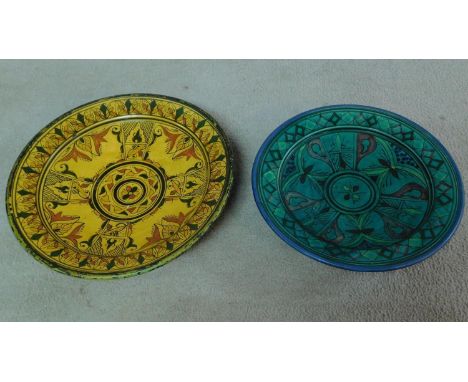 A pair of ceramic glazed plates with bold geometric designs. 39x39cm (largest) 